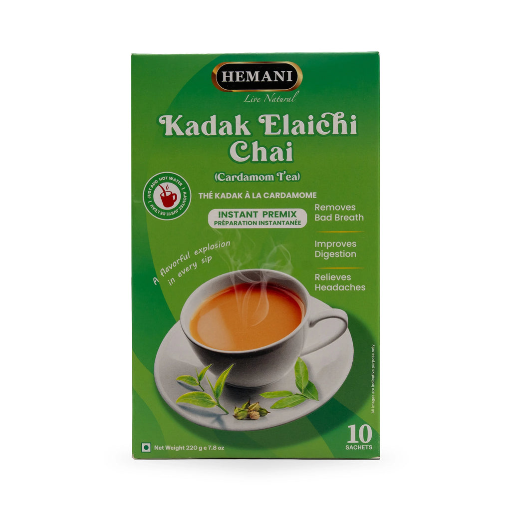 Hemani Kadak Elaichi Chai Cardamom Tea box with steaming cup and green leaves