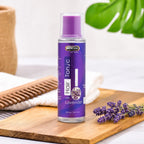 Lavender hair tonic in purple bottle with fresh lavender sprigs on wooden board, natural hair care