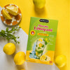 Hemani Masala Limopani instant lemon drink mix with fresh lemons and mint on vibrant yellow background