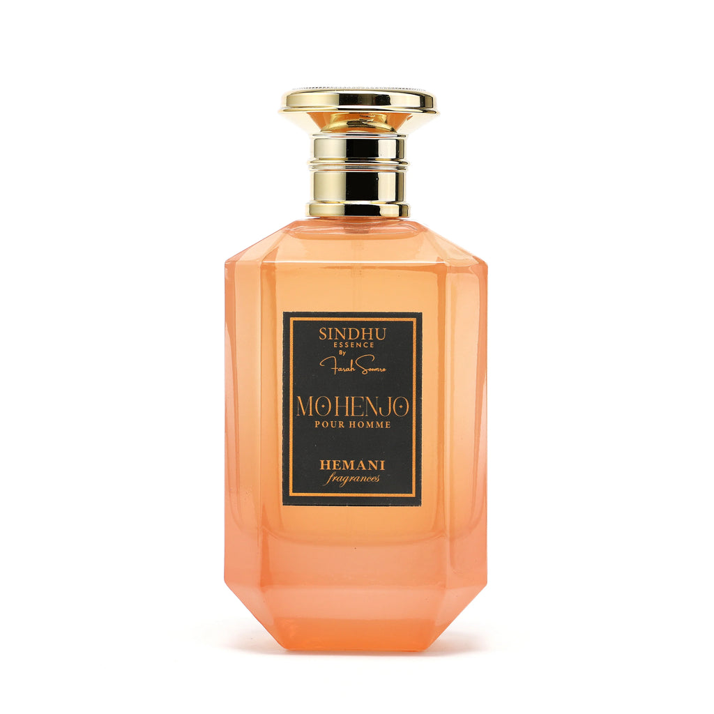 Mohenjo Pour Homme fragrance by Hemani, featuring a sleek orange bottle with gold accents and elegant label design.